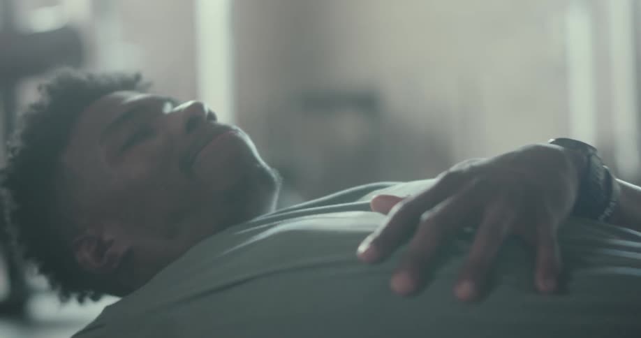 A man lies on the floor as he exercises