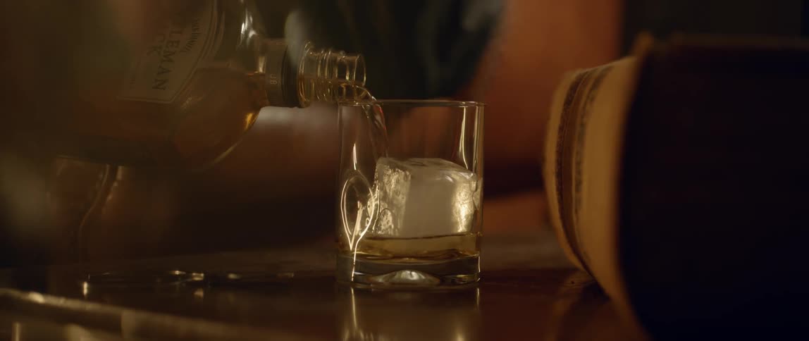 A drink is being poured in a glass