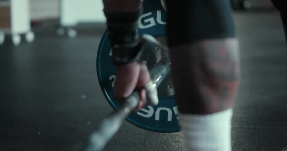 A man lifts a large weight plate