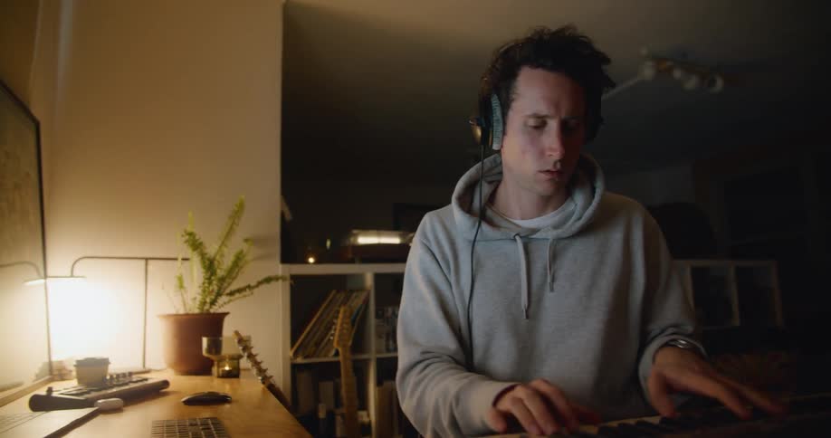 A man plays his piano then types on his keyboard