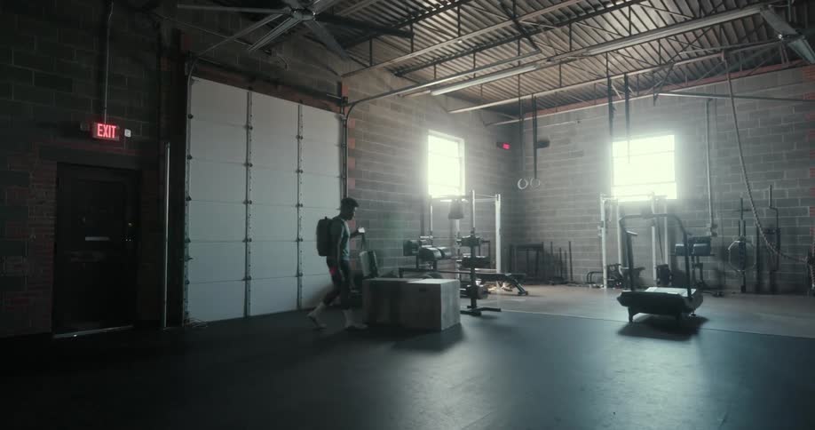A man enters the gym getting ready for a workout