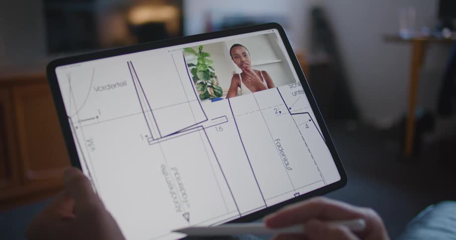 A person is sketching on a tablet while on a video call