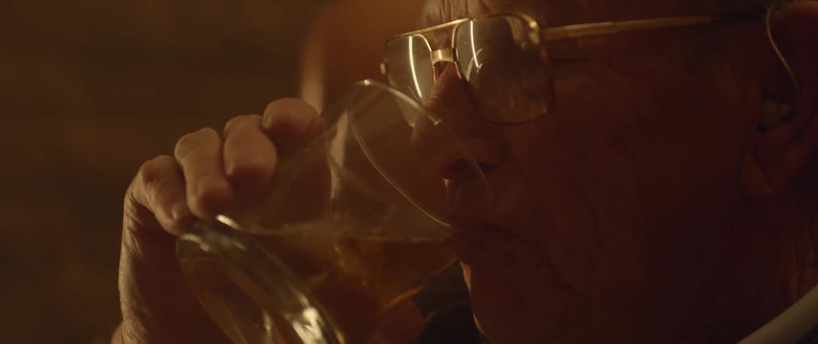 A man is drinking from a glass