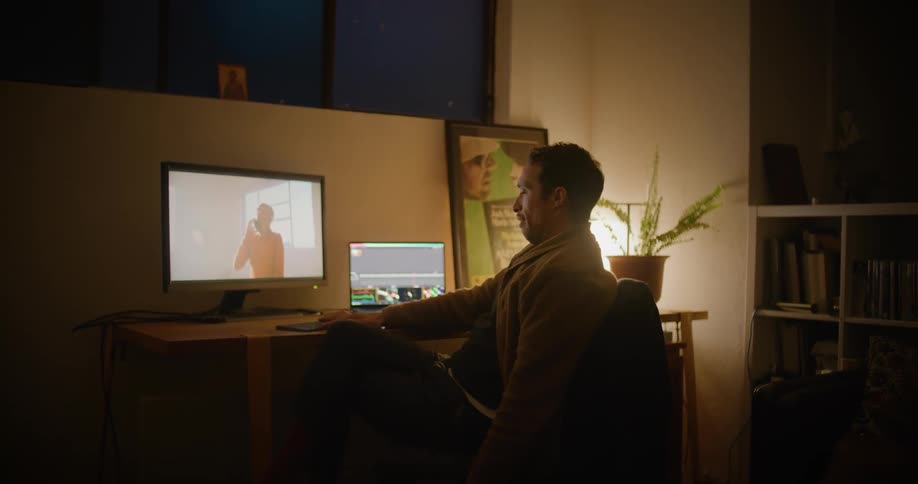 A man stretches in his chair while hes working on a computer