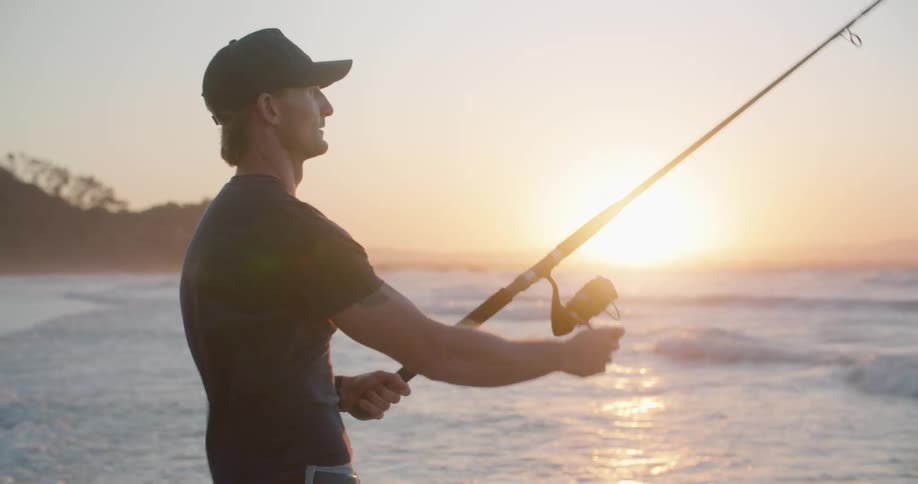A man is fishing from the beach