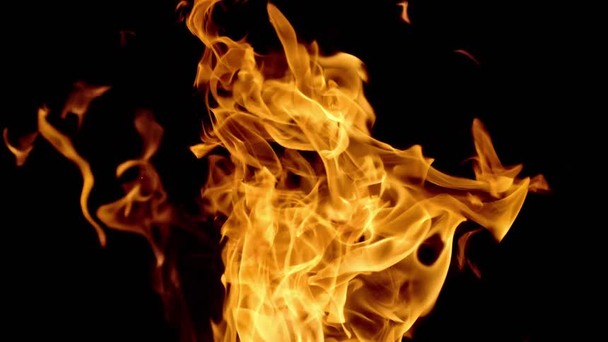 Orange flames rise against a black background