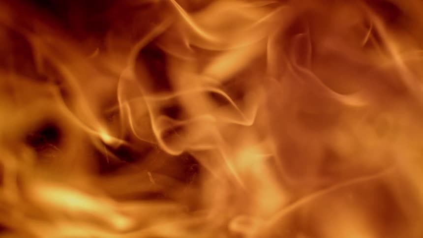 Orange flames billow in small waves