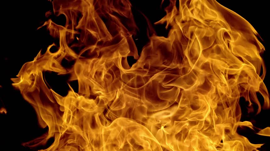 Orange fire flames against a black background