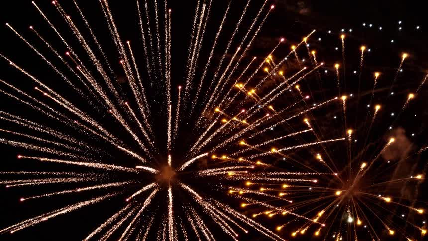 Fireworks are being set off producing bright coloured patterns