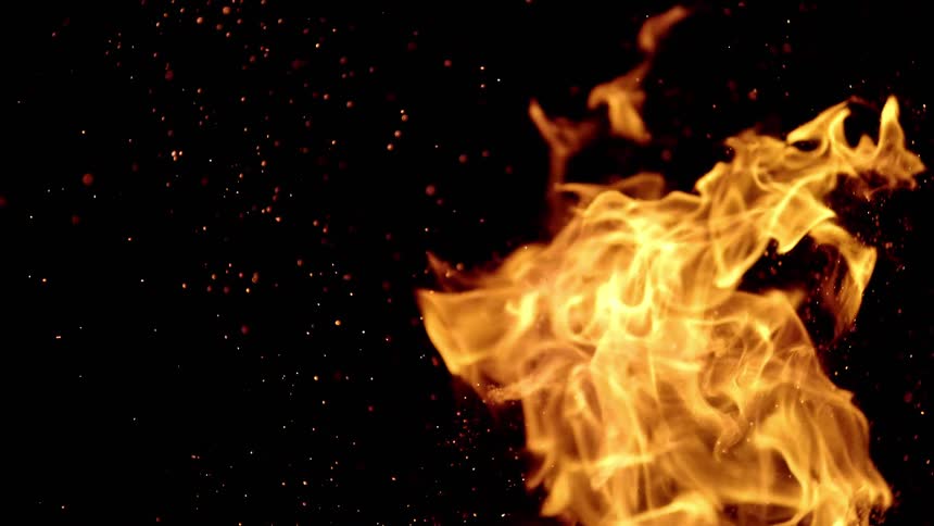 Orange bright fire flames shoot sparks at night