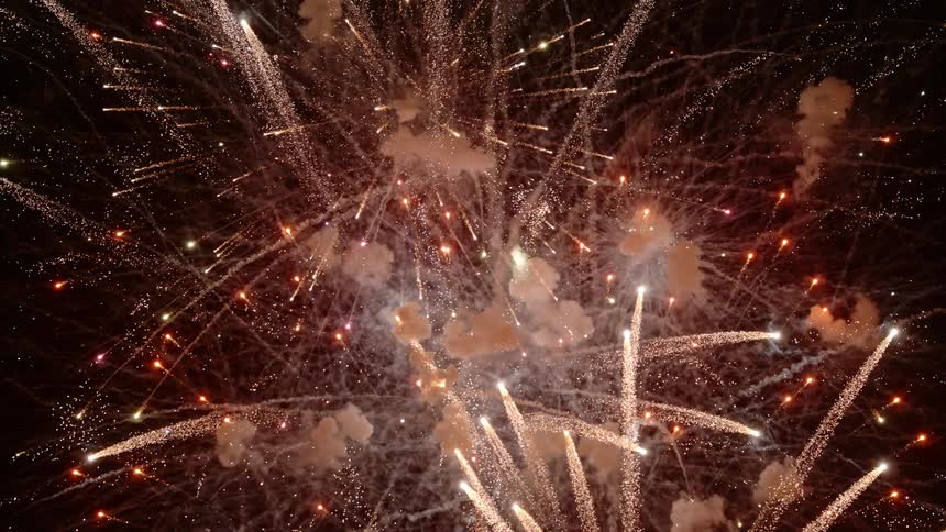 Bright colorful fireworks show display exploding on the night sky