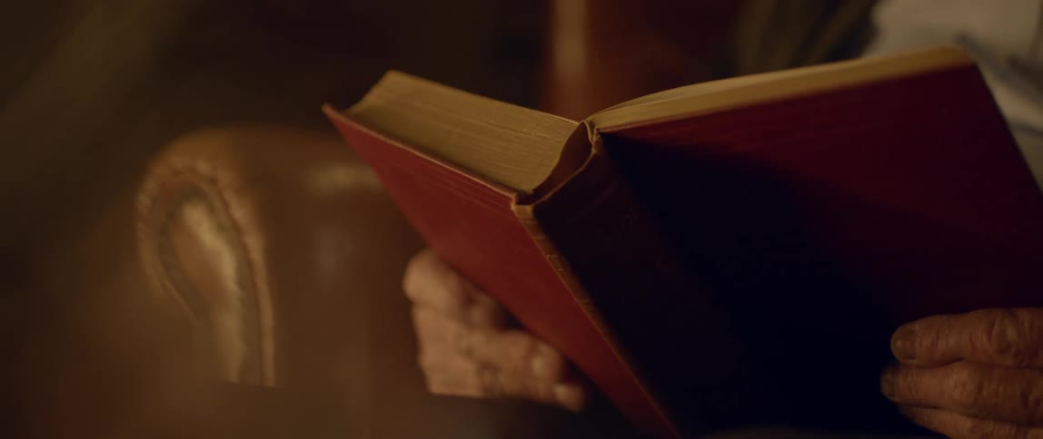 Close up of a book being read by a person seated