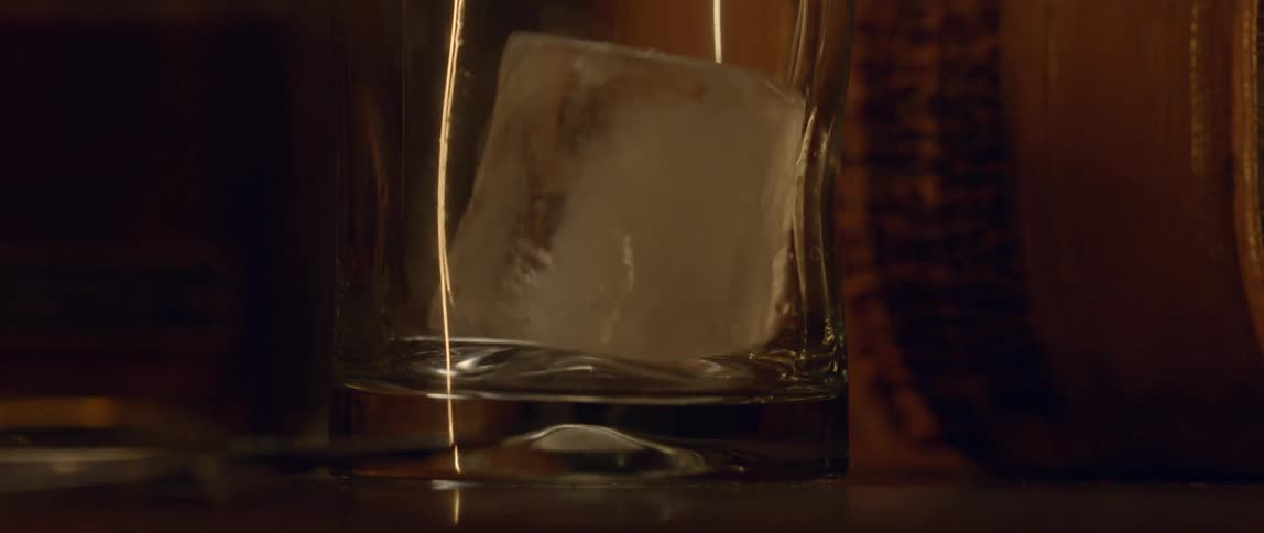 Ice cube hitting the bottom of a glass