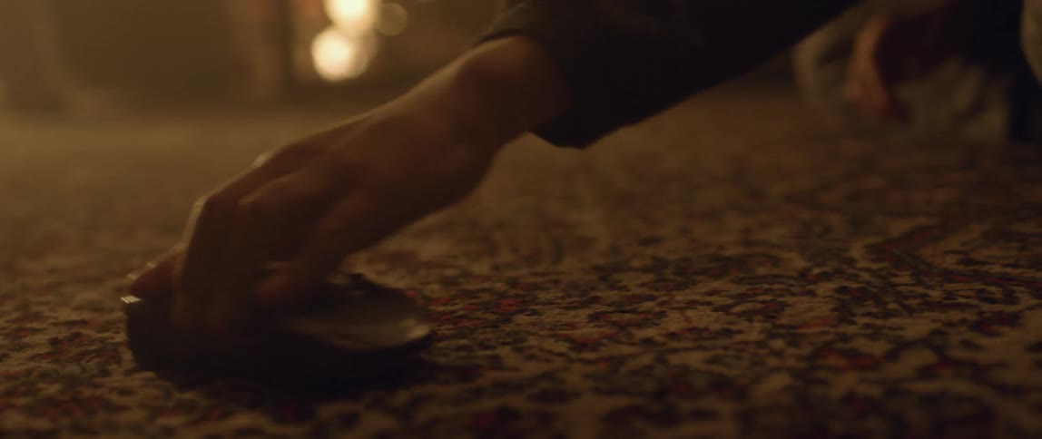 A child moves a toy car on a carpet
