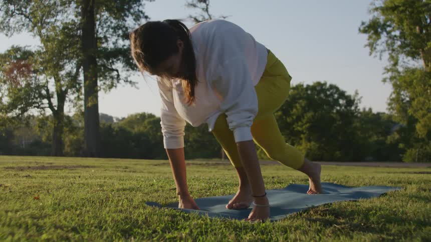 A woman doing yoga outdoors
