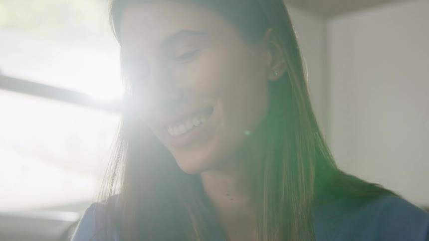 A woman is talking and smiling