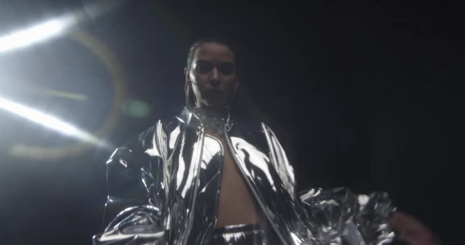 A close up of a woman standing in a fashion outfit