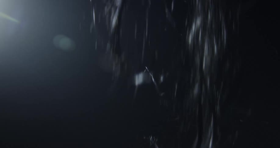 Hair is falling from above in the darkness