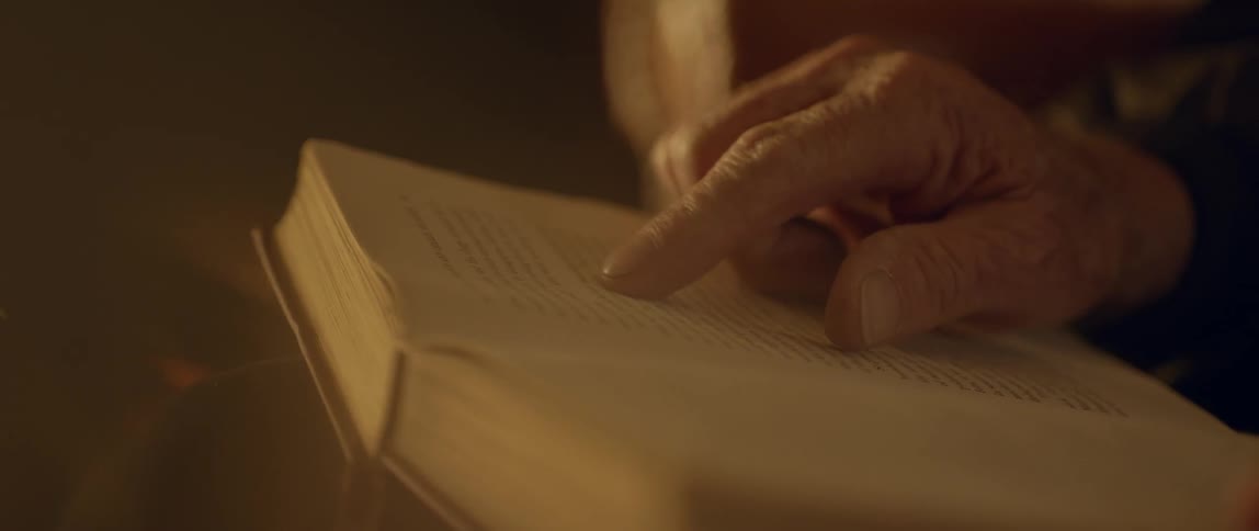 A hand is tracing the words in a book