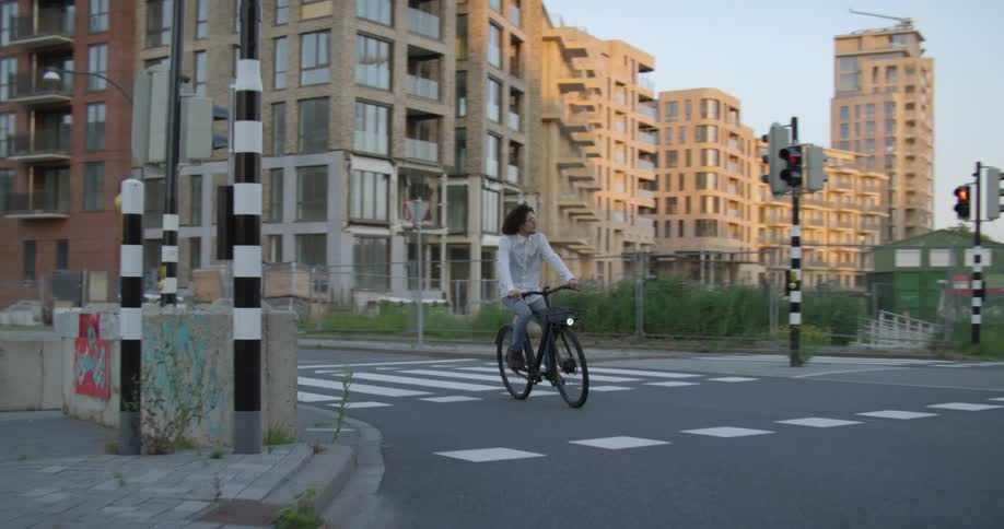 A man is riding his bicycle on a city street