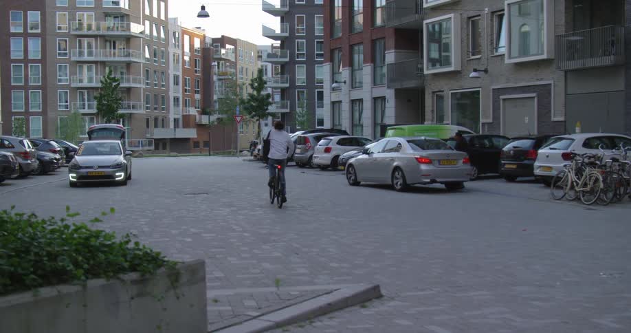 A man riding a bicycle down a city street