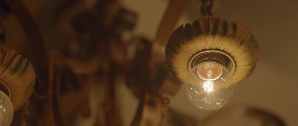 A round light bulb shining in a dim room