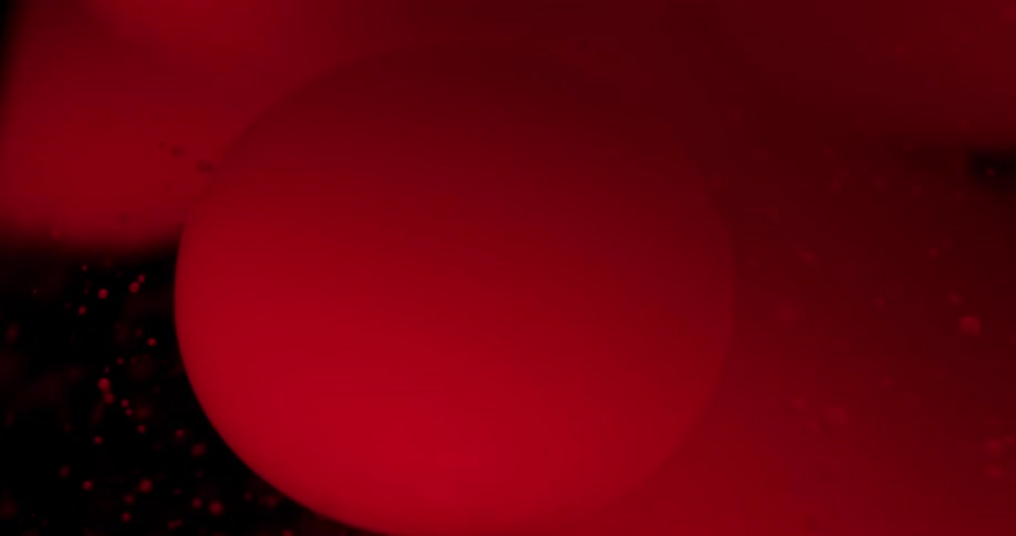 Abstract red spheres move in the liquid