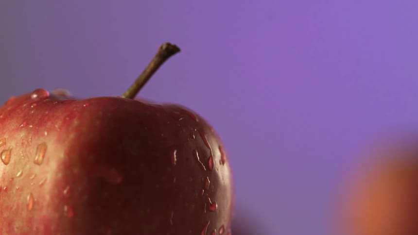 The apple is wet and dripping water