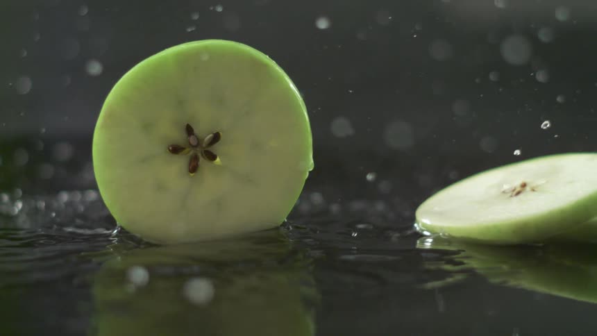 A close up of fruit being splashed with water