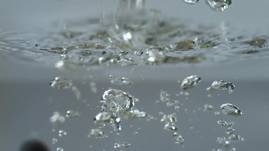 A view of fruit dropping into water