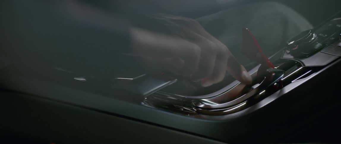 A person flips up a red piece and pushes a button