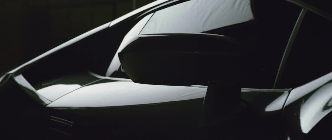 A dark car inside a bright room