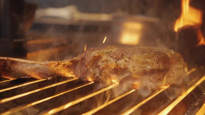 A piece of meat cooking on a grill