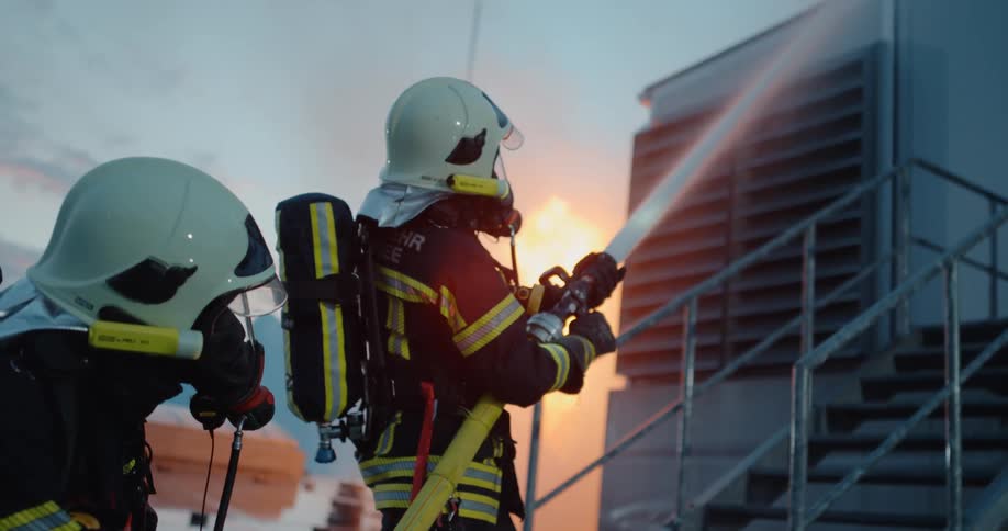 Two firefighters trying to put out a fire