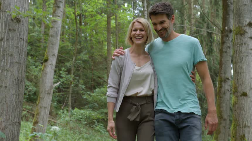 A family walking and running in a forest