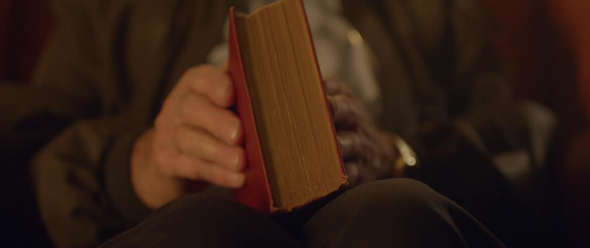 A man closed a red book