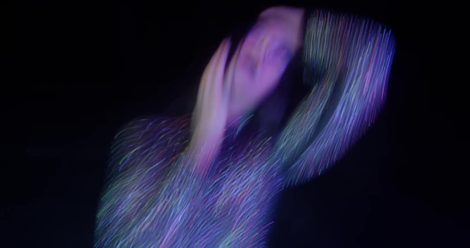 A woman spins as she dances on a stage