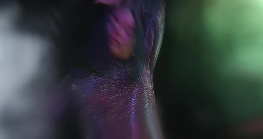 Woman wearing sparkling outfit dance near colored lights