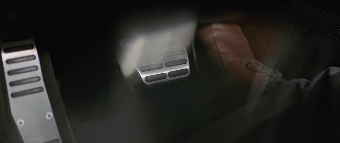 A foot presses on the gas