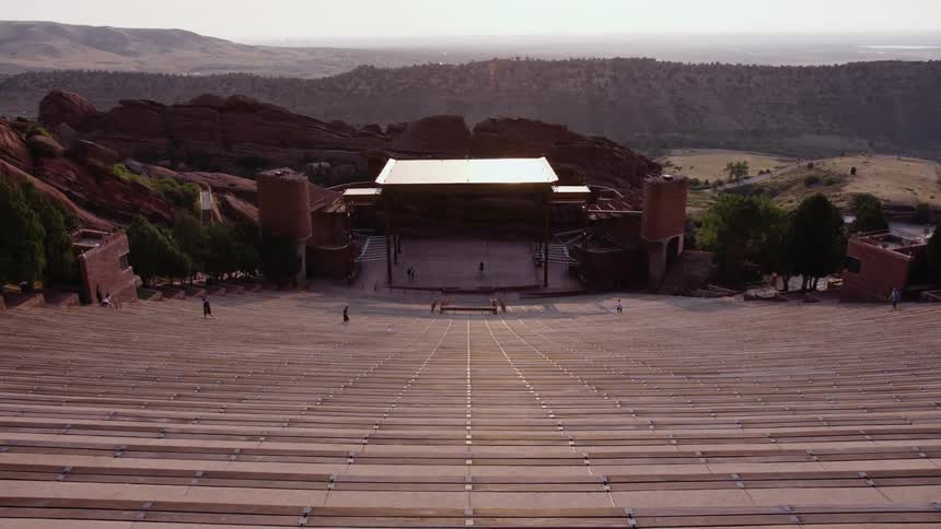 People are walking on stairs at a concert stadium in a rural area