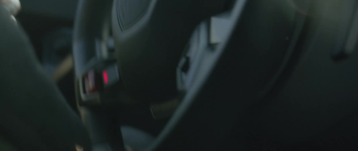 A man drives a sports car frantically