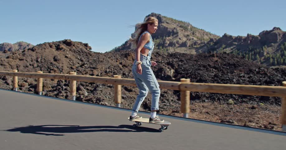 A woman skateboarding outdoors during the day