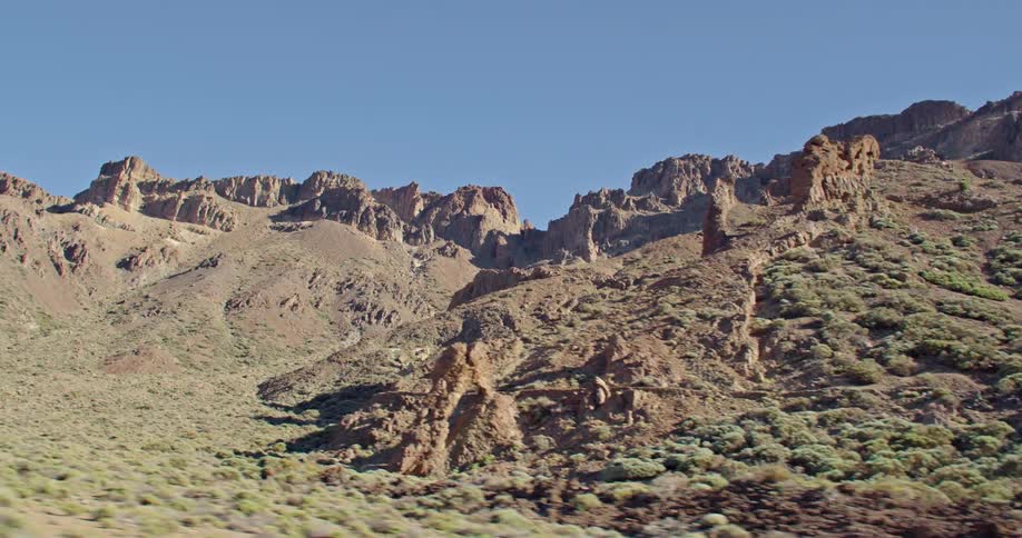 A desert landscape with cliffs the sky and clouds in the background