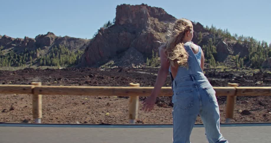 A woman skateboarding outdoors