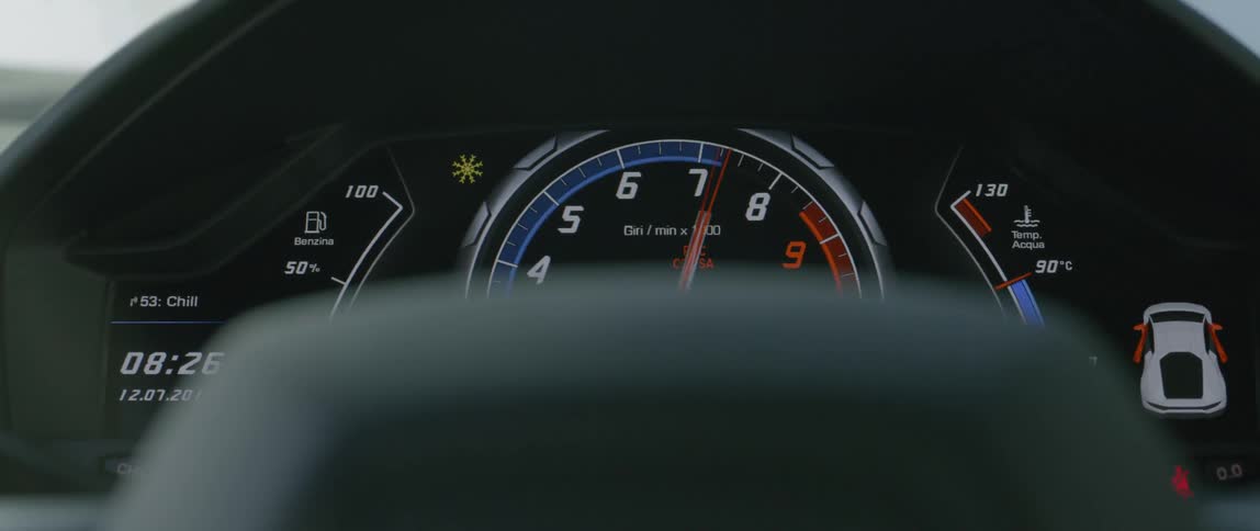The dashboard of a car is shown while a dial cranks up