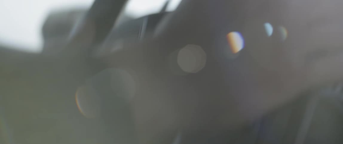 Close up of hands steering a wheel of a car that is shaking