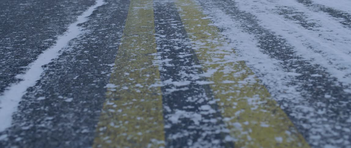 Snow is scattered over a road