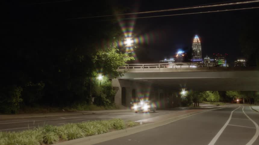A car races down the street at night
