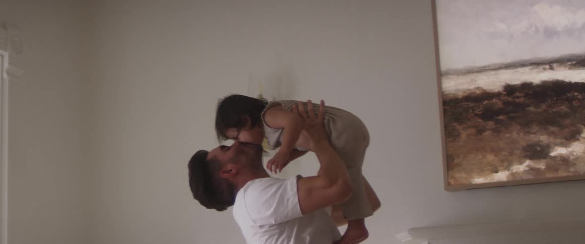 Father picking up and kissing his child