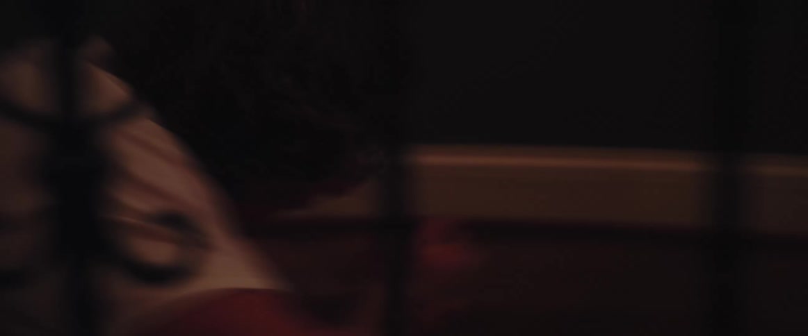 Young man being dragged face down through a hallway